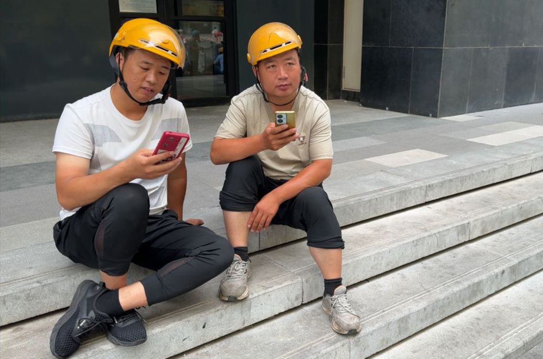 Food delivery worker Yang (left) speaks to CNN about his plight.